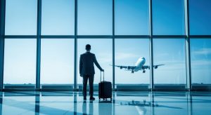 man awaiting for his flight in an airport terminal