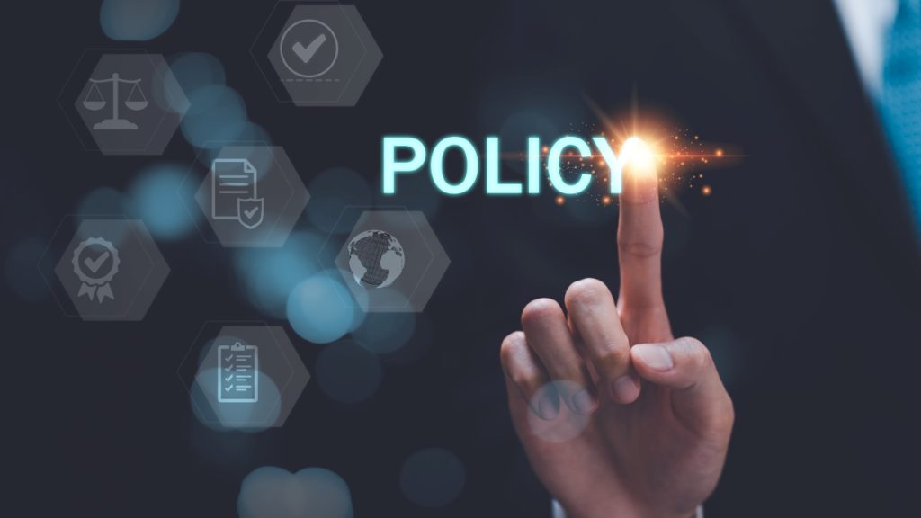 man pointing at virtual icon that says policy