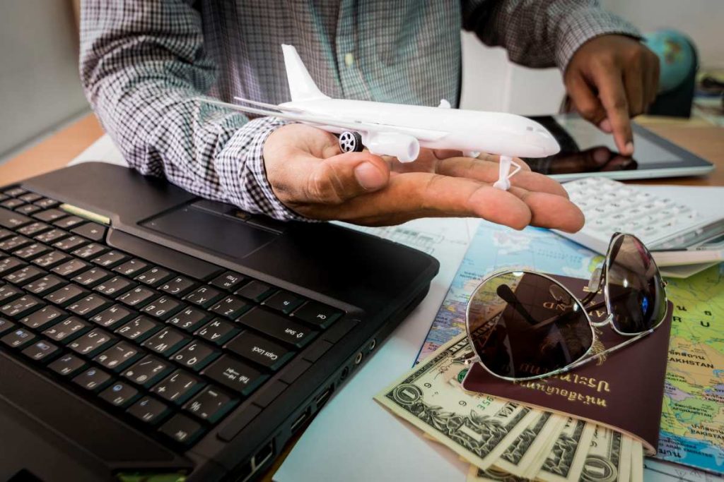 A man holding a model airplane on a desk