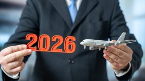 A passenger plane and 2026 in the hands of a businessman. Aviation trends and news