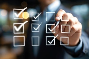 Travel Management Company completing a checklist with digital checkmarks