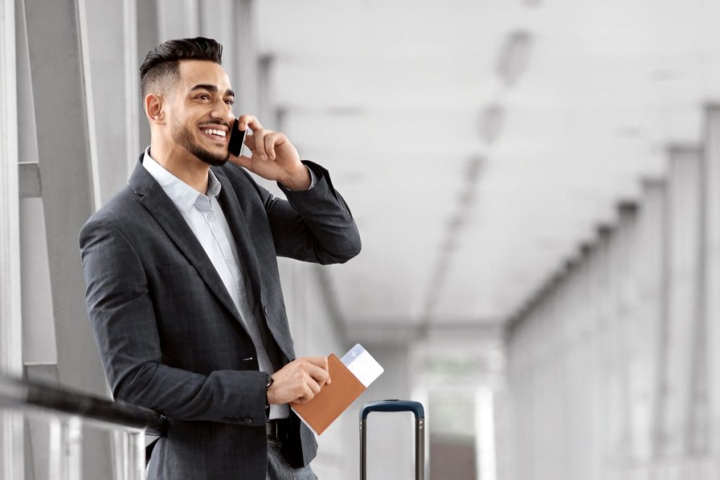 Businessman Talking On Cellphone In Airport