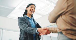 Handshake, deal and business women in office with meeting, sale or closing on property listing